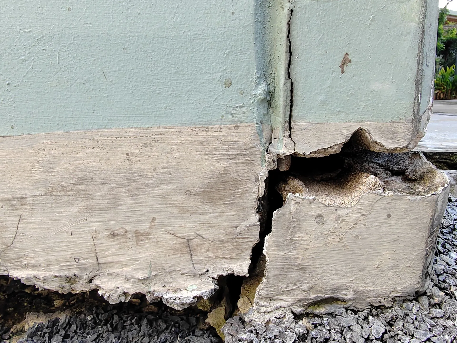A close up of a concrete wall with a hole in it.